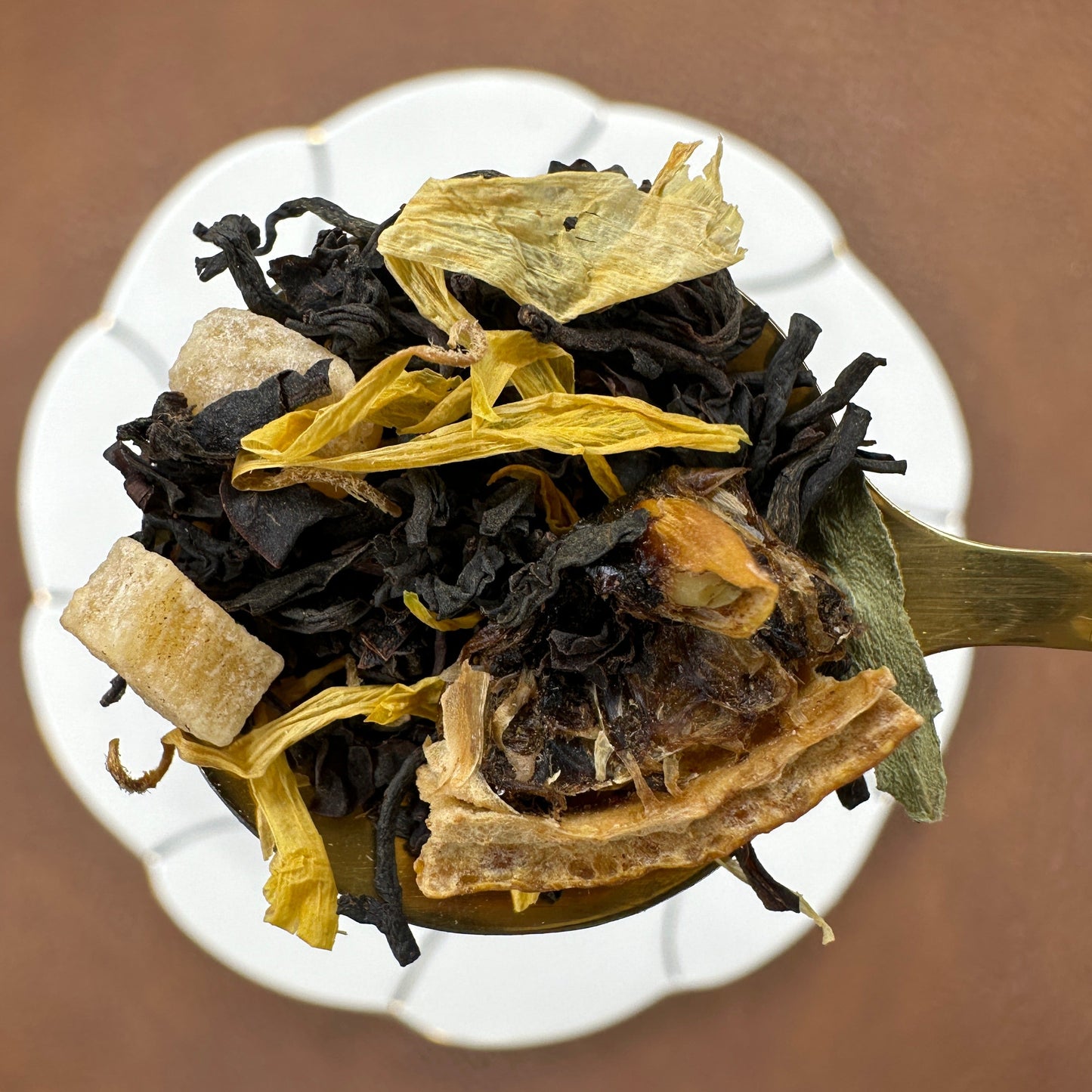 Lemon Ginger, flavored black loose leaf tea on gold teaspoon