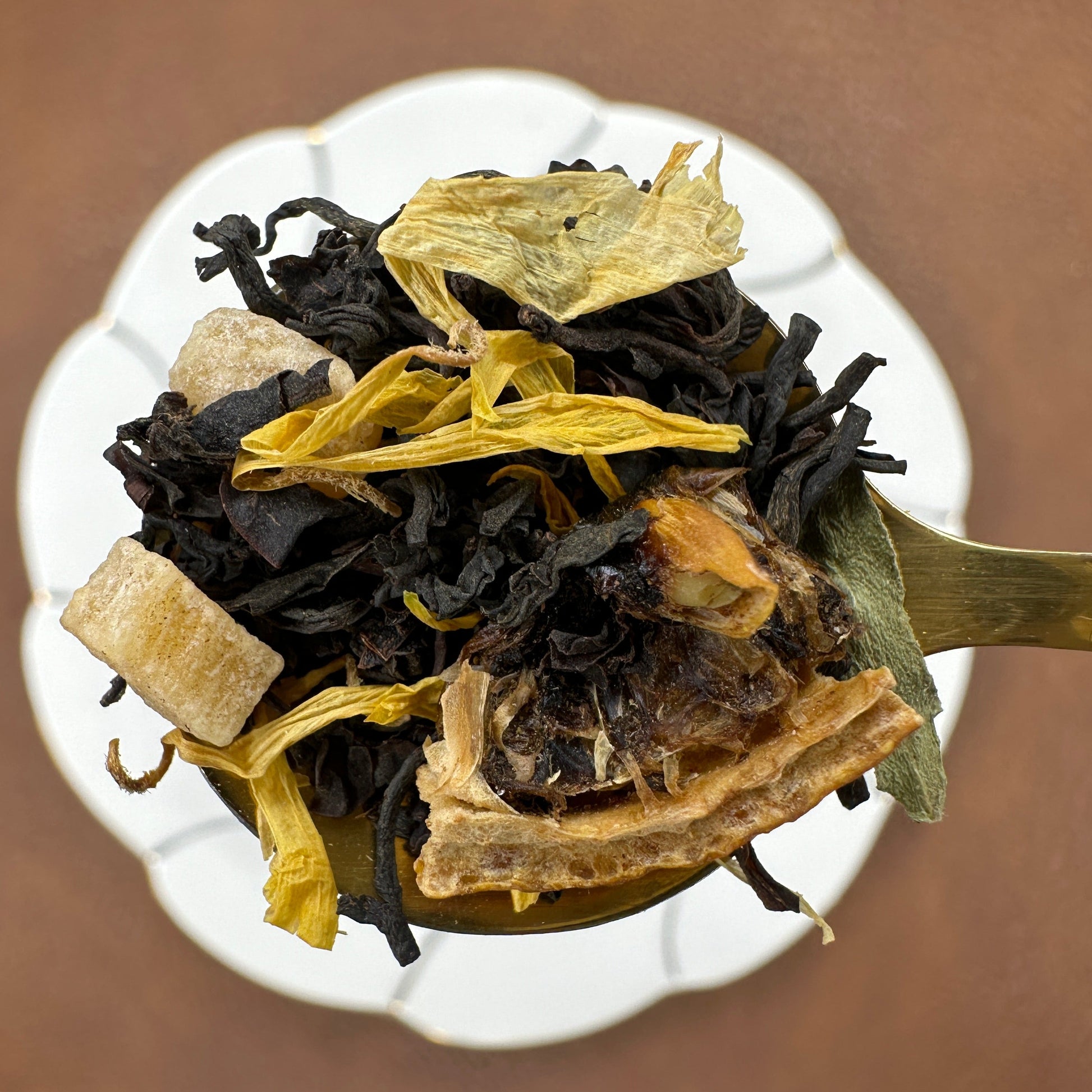 Lemon Ginger, flavored black loose leaf tea on gold teaspoon